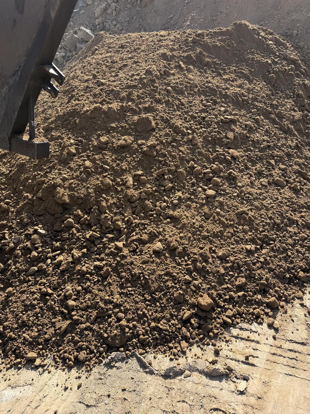Clean fill dirt loaded in a dump truck bed, ready for delivery